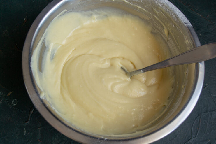 Mixing The Batter Stirring the light cake batter in a bowl with a spoon