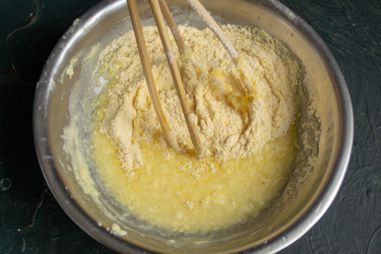 Mixing the dough Folding dry ingredients into the wet mixture to form the cookie dough.