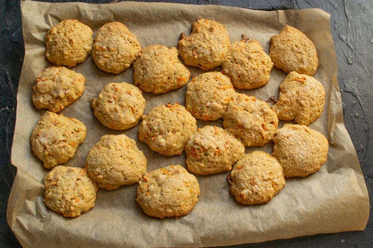Baking in the oven Baked golden carrot cookies on a baking sheet