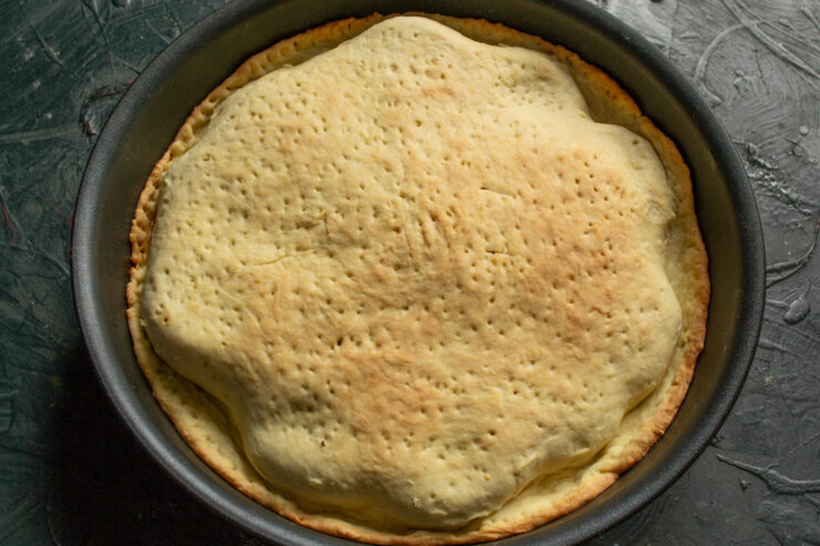 Baked Result Baked golden brown pastry crust sitting in a skillet