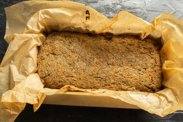 Freshly baked pate Baked chicken liver pate inside a rectangular parchment-lined baking mold.