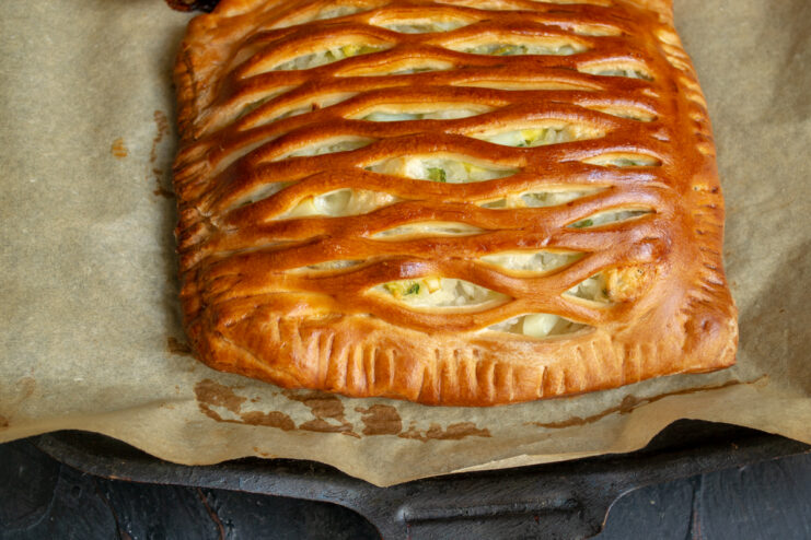 Golden brown baked pie resting on a tray in the oven