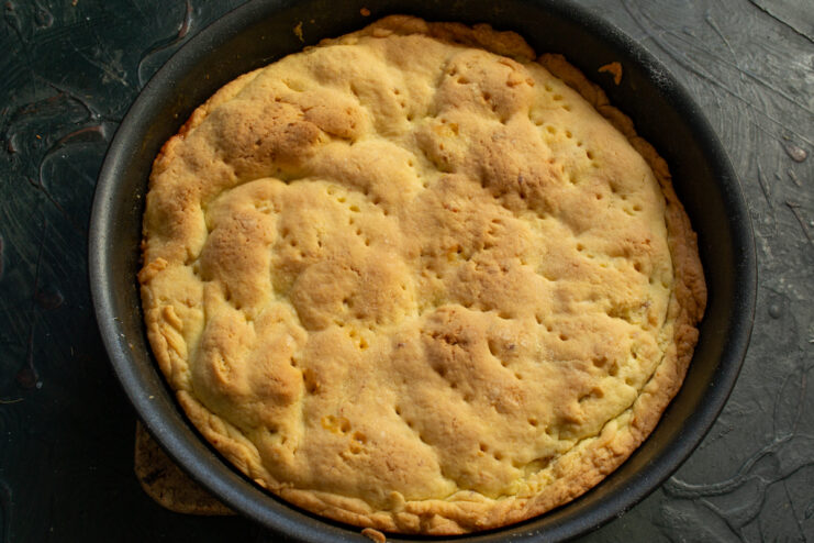 Baked golden tart in a skillet fresh out of the oven.
