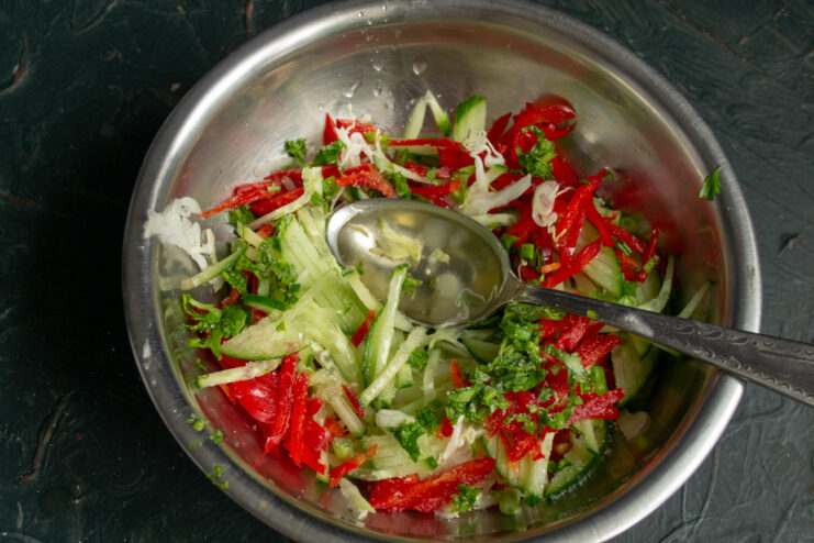 Dressing the salsa salad Dressing the vegetable salad with oil and vinegar