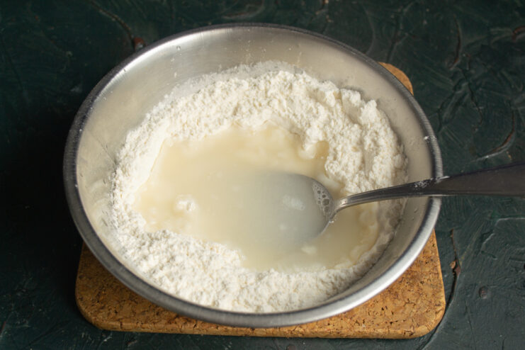 Mixing flour and hot water with a spoon