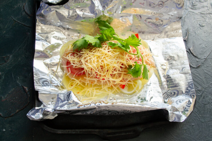 Adding sauce and herbs Fresh herbs and a dollop of mayonnaise on top of the cheese