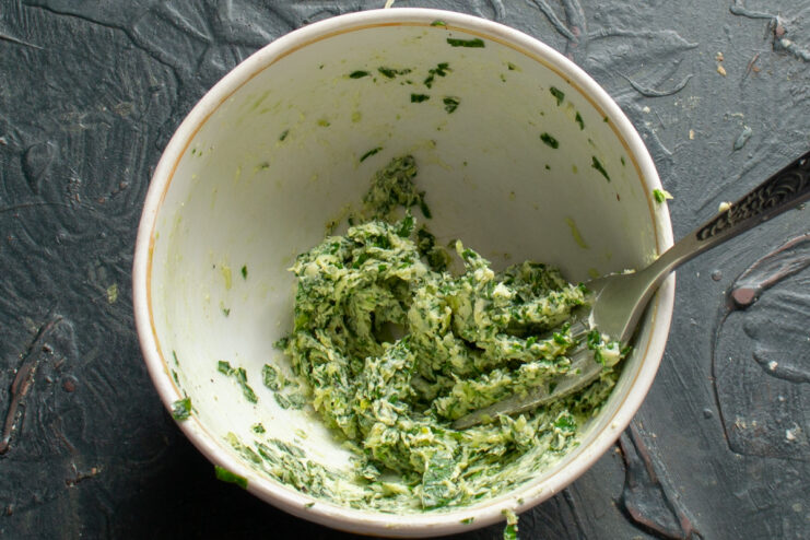 Mashed garlic and herb compound butter in a bowl