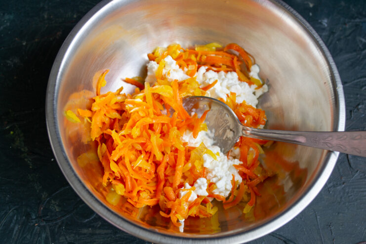 Mixing the curd filling Mixing farmer's cheese with sautéed carrots and onions.