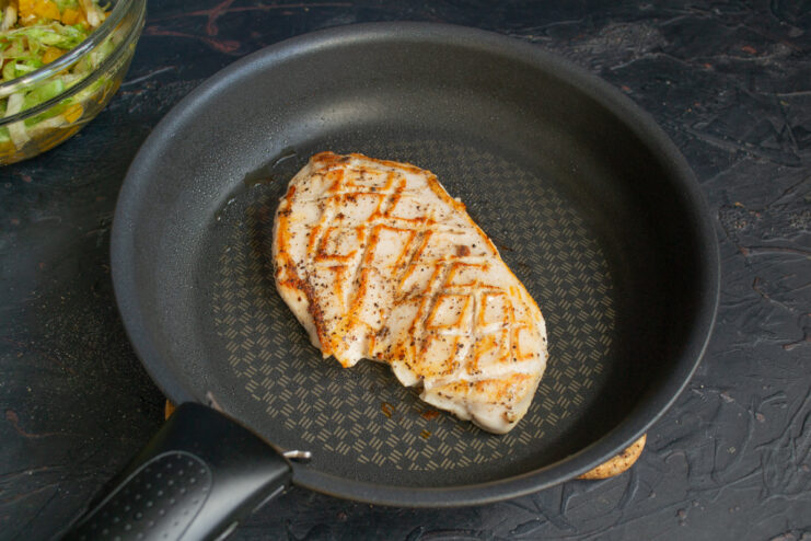 Searing the chicken Chicken fillet searing in a non-stick skillet until golden brown