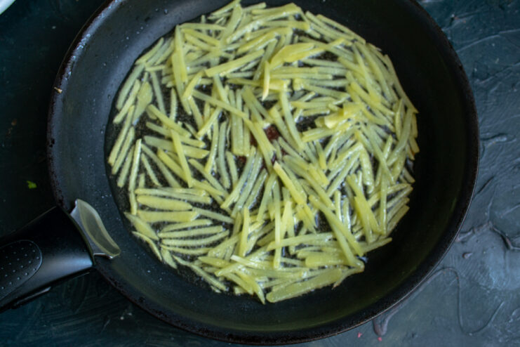 Frying shoestring potatoes Frying shoestring potatoes in a hot skillet