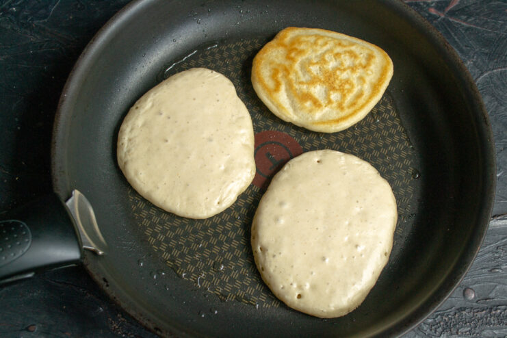 Frying the pancakes Frying pancakes in a skillet until bubbles appear