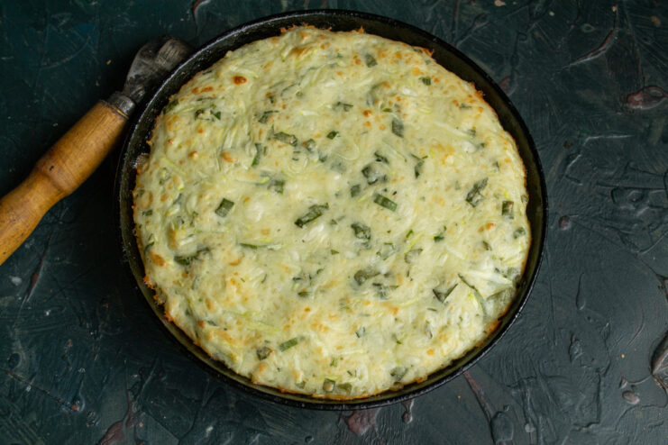 Finished baked casserole Golden brown zucchini casserole freshly baked in a cast-iron skillet