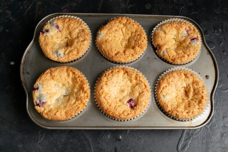 Golden brown baked muffins in a metal tin