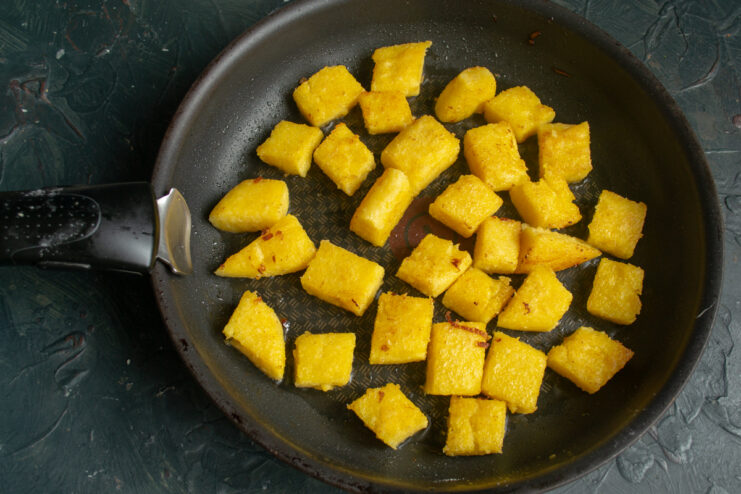 Finished Fried Polenta Golden brown pan-fried polenta cubes