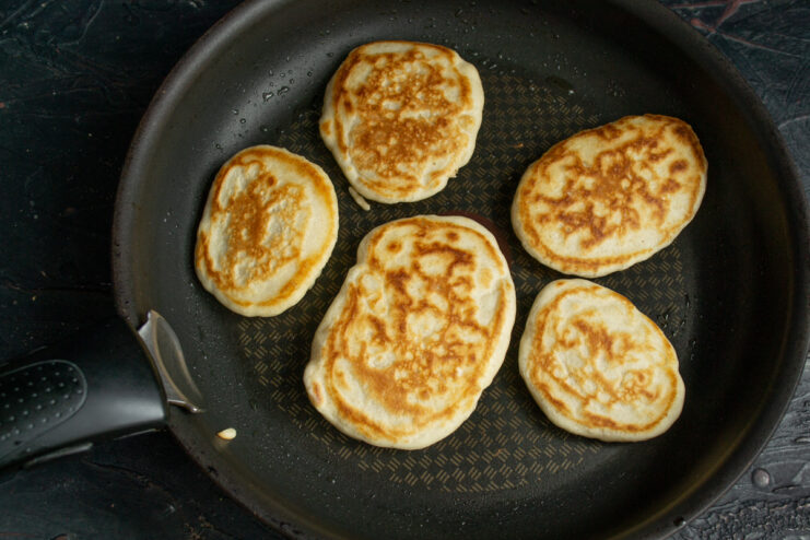 Flipping the pancakes Golden sourdough pancakes cooking on the second side