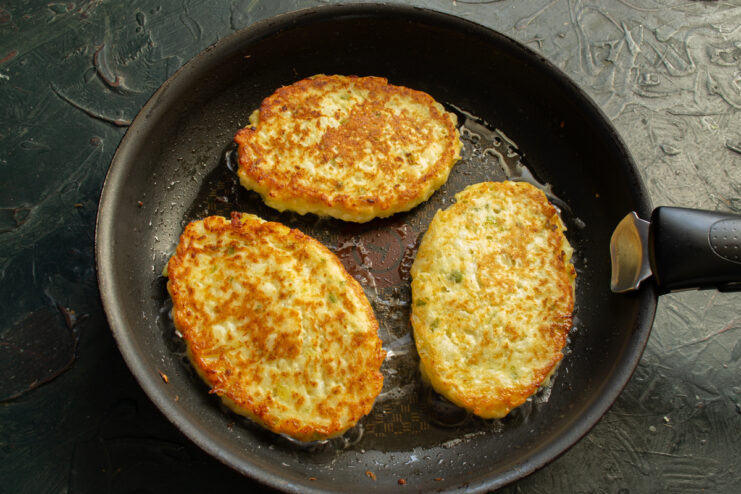 Frying Until Golden Frying cauliflower schnitzels in a hot skillet until golden brown