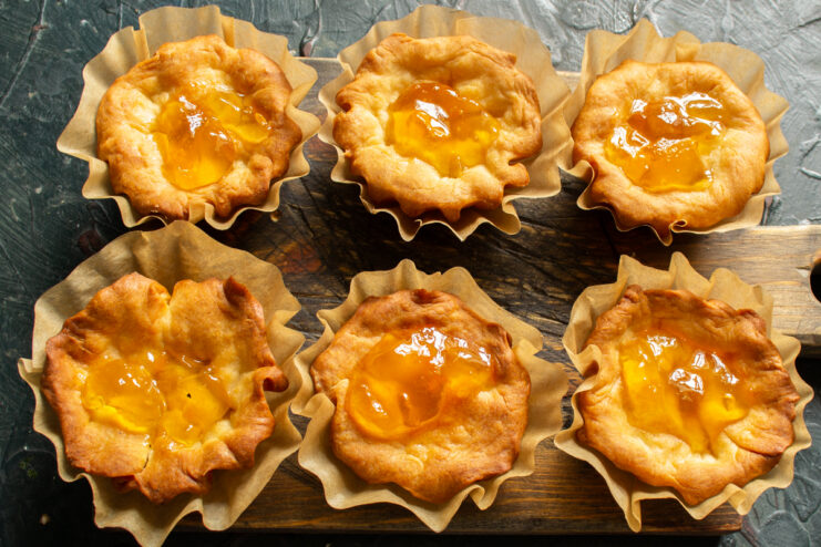 Filling Shells With Apricot Jam Layer of bright apricot jam spread inside the baked pastry shells