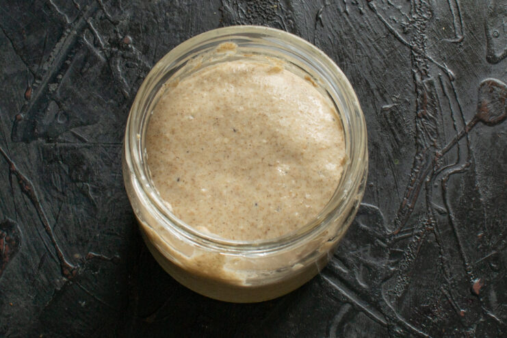 Active bubbling starter Active and bubbling sourdough starter expanded inside a glass jar
