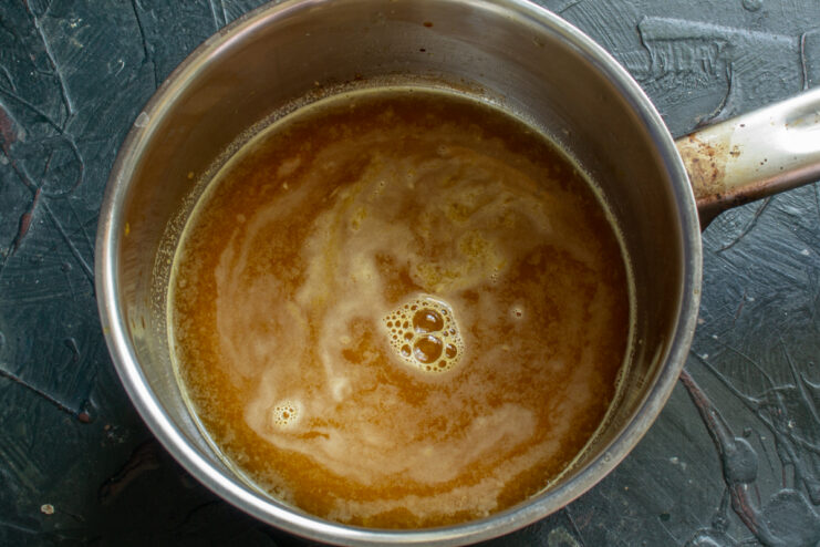 Boiling the syrup Orange syrup simmering in a saucepan on the stove