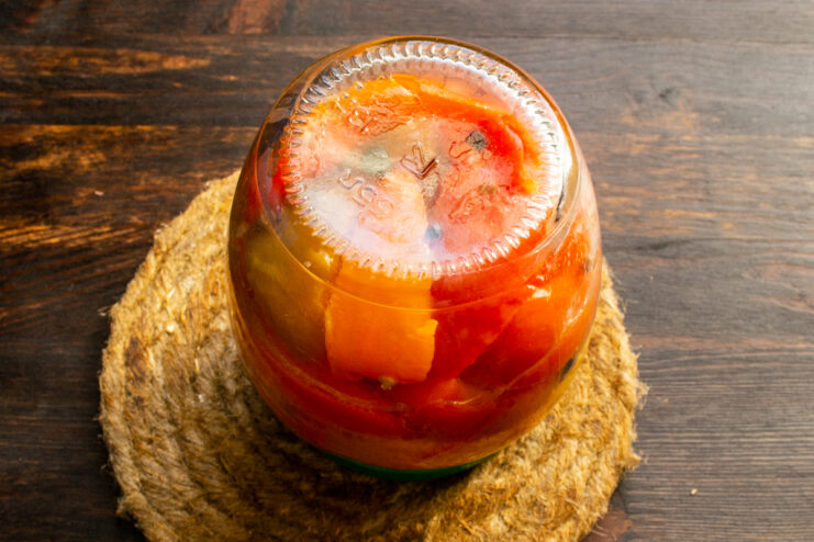 Cooling the sealed jars Inverted jar of pickled peppers resting on its lid