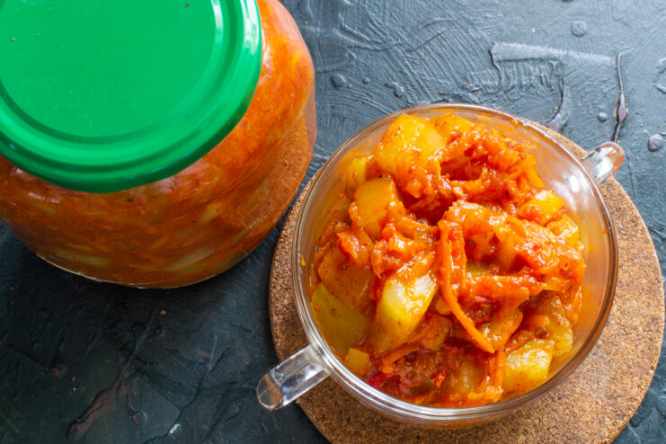Jar of zucchini sauté and a serving in a bowl