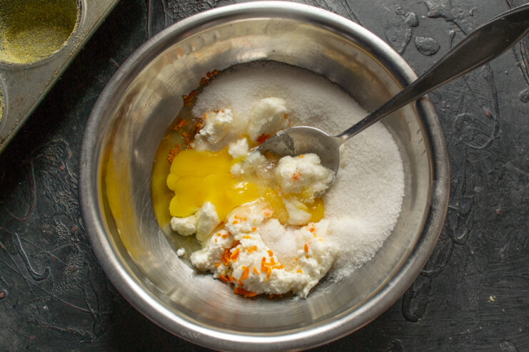 Adding sugar for sweetness Adding fine sugar into the mixing bowl to sweeten the muffin batter