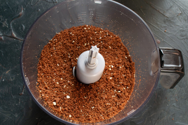 Sponge cake crumbs with almonds in a blender.