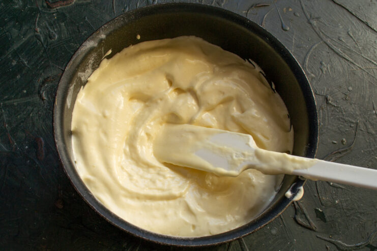 Batter In The Baking Pan Sponge cake batter spread evenly in a round pan