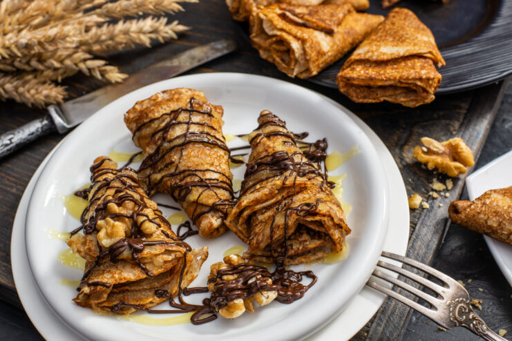 Whole wheat crepes drizzled with honey and chocolate topped with walnuts