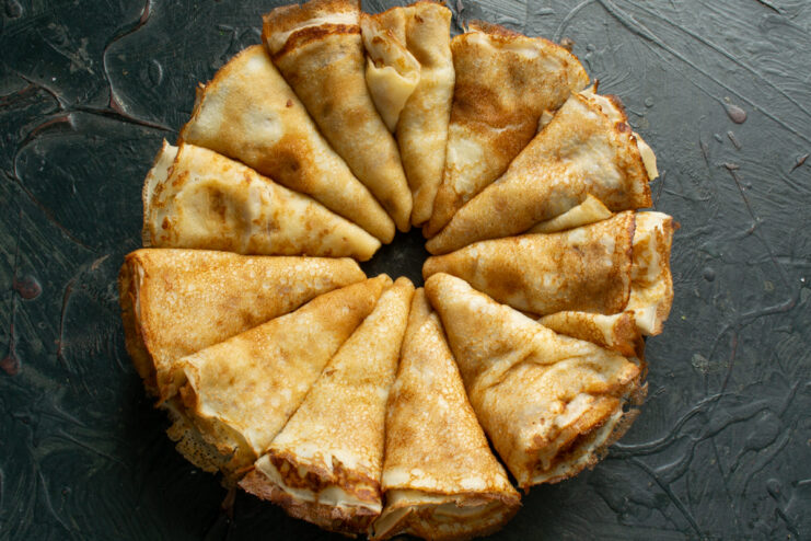 Folding crepes into triangles for dipping Crepes folded into triangle shapes ready for dipping