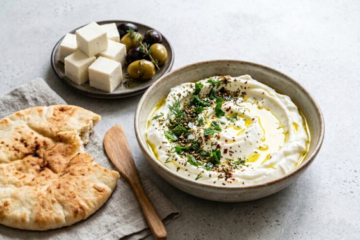 Labneh Appetizer Middle Eastern Labneh dip drizzled with olive oil and sprinkled with herbs.