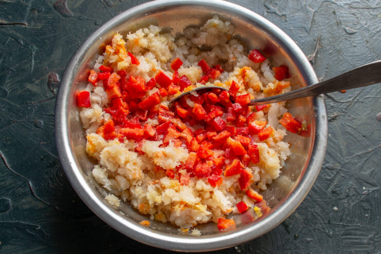 Diced bell pepper mixed into the ground fish