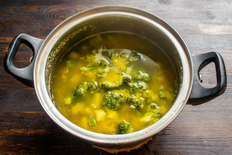 Boiling broccoli in the soup Broccoli florets cooking in the vegetable broth