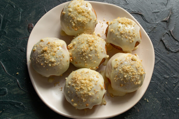 Decorating with Cake Crumbs Sprinkling baked cream buns with sponge cake crumbs for texture