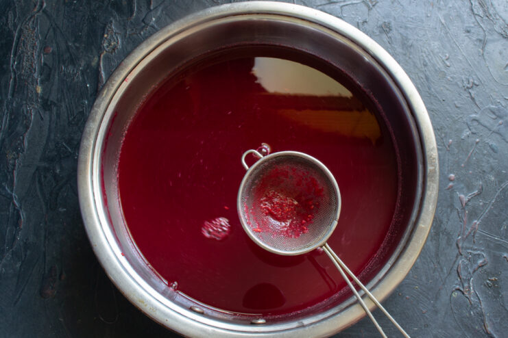 Clear raspberry juice Clear raspberry juice in a pot with a small sieve