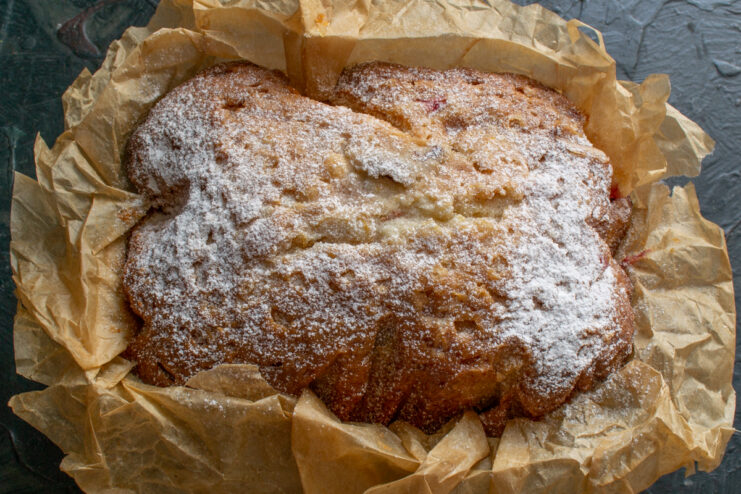 Finished cake appearance Whole fruit cake dusted with powdered sugar