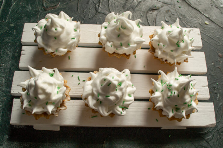 Final Dessert Decoration Decorating meringue tartlets with colorful confetti sprinkles