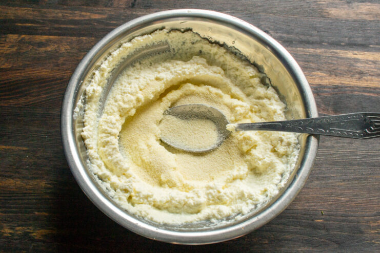 Adding the semolina Mixing semolina into the creamy ricotta base