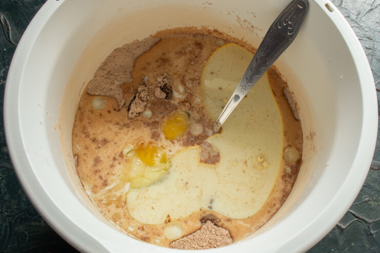 Adding Wet Ingredients Pouring milk into a stand mixer bowl