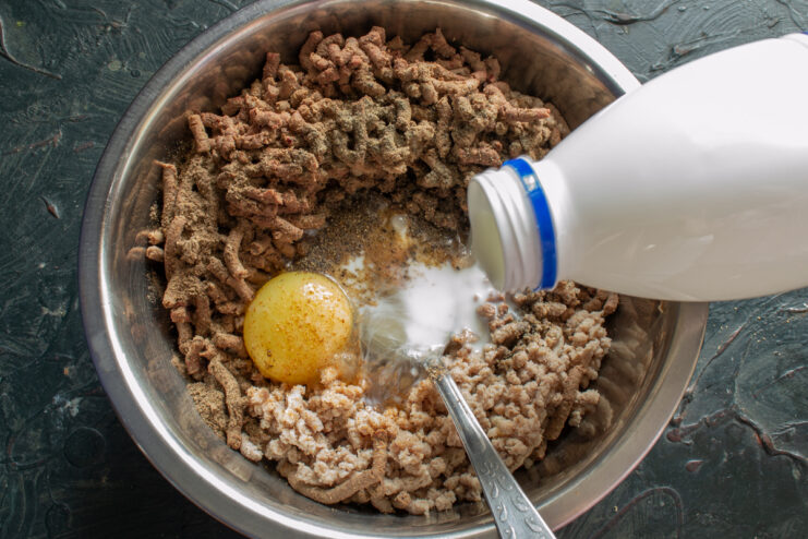 The Secret To Tenderness Pouring milk into the spiced meat filling mixture