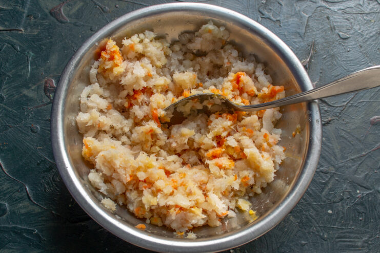 Adding sauteed carrots to the ground fish mixture