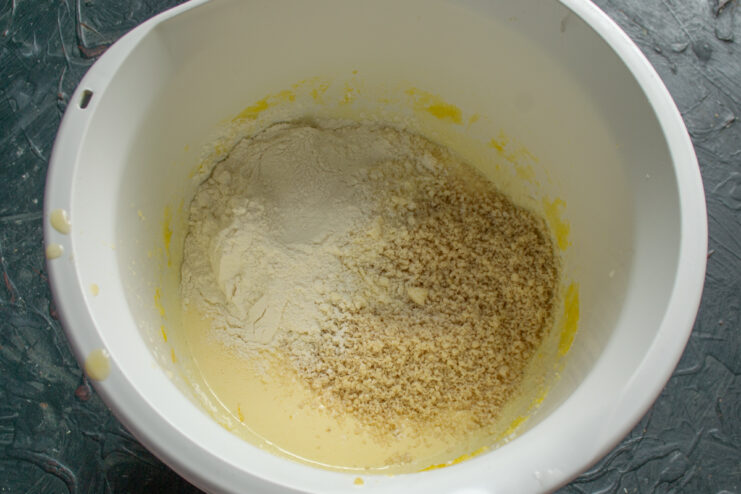Mixing Dry Ingredients Adding flour and ground nuts to a mixing bowl