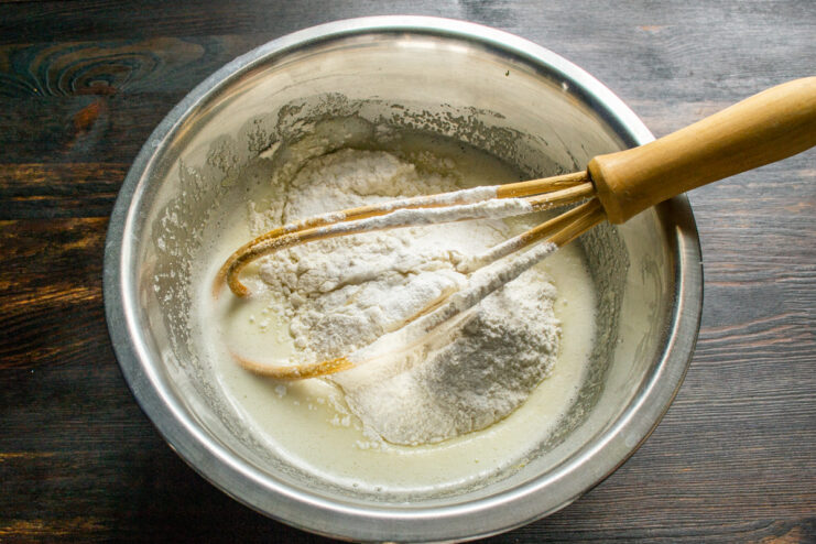 Sifting flour and baking powder Adding sifted wheat flour and baking powder to the batter