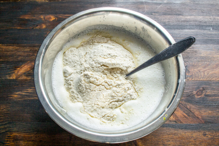 Adding the flour Adding all-purpose flour to wet crepe ingredients