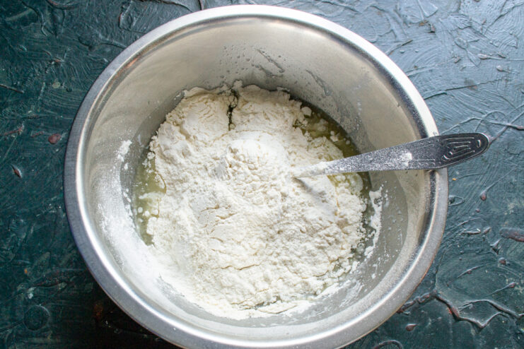 Sifting dry ingredients into the bowl Sifting flour and baking powder into wet ingredients