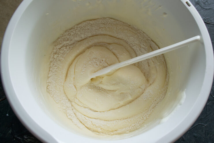 Adding dry ingredients Folding flour into the whipped egg mixture with a spatula