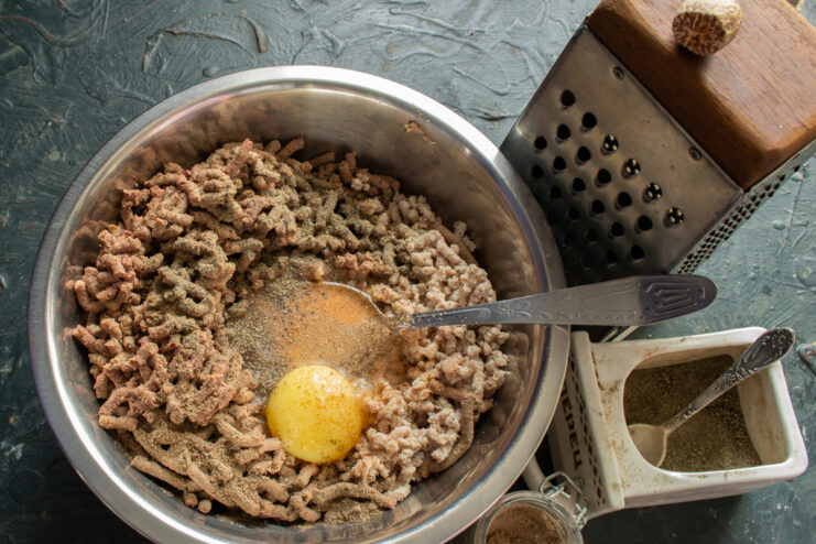Sausage Spices Sprinkling nutmeg and black pepper over the sausage filling