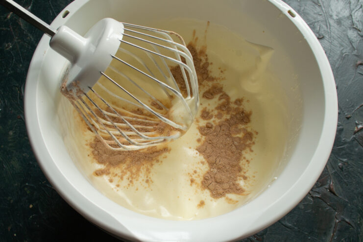 Folding in the flour Folding sifted flour and cocoa into whipped eggs