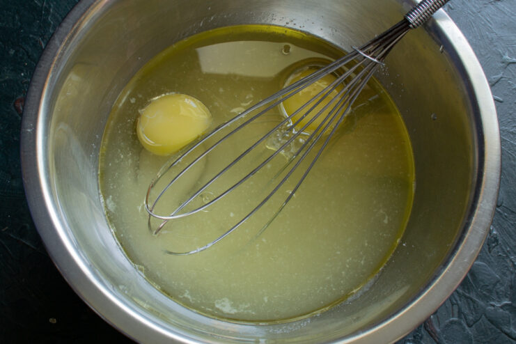 Adding oil and sugar Adding neutral vegetable oil and sugar to the egg mixture