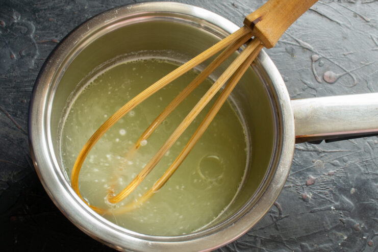 Pouring vegetable oil into boiling water in a saucepan